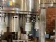 Llenadora rotativa gravim�trica de acero inoxidable con cabina